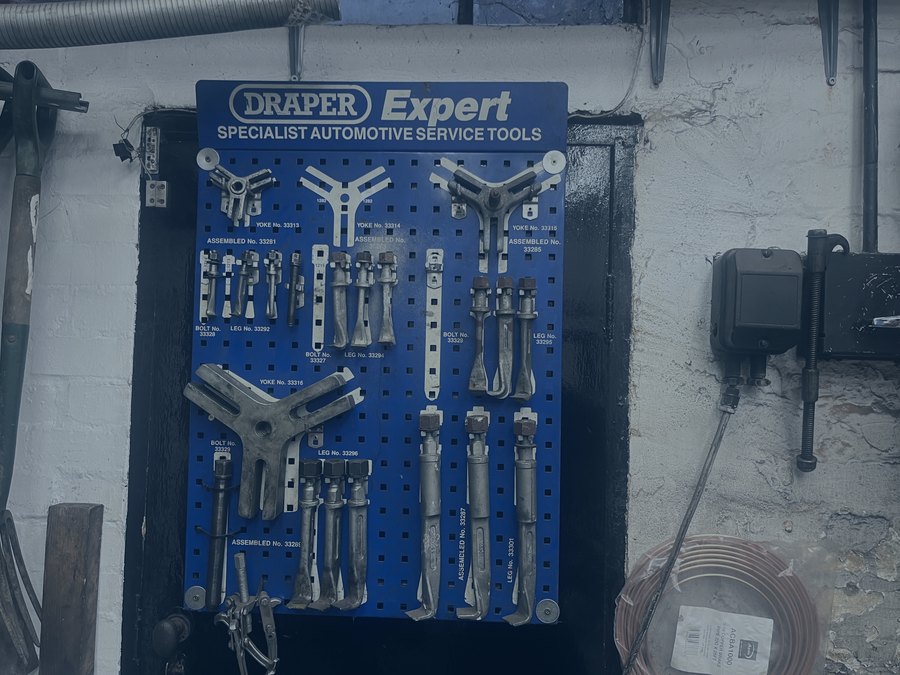 Specialist automotive puller tools on the wall at R. Taylor Workshop